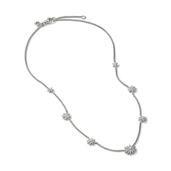 A silver necklace with a series of small flower-shaped charms evenly spaced along a delicate chain. The necklace features an adjustable clasp closure at the end. The design has a simple and elegant aesthetic.