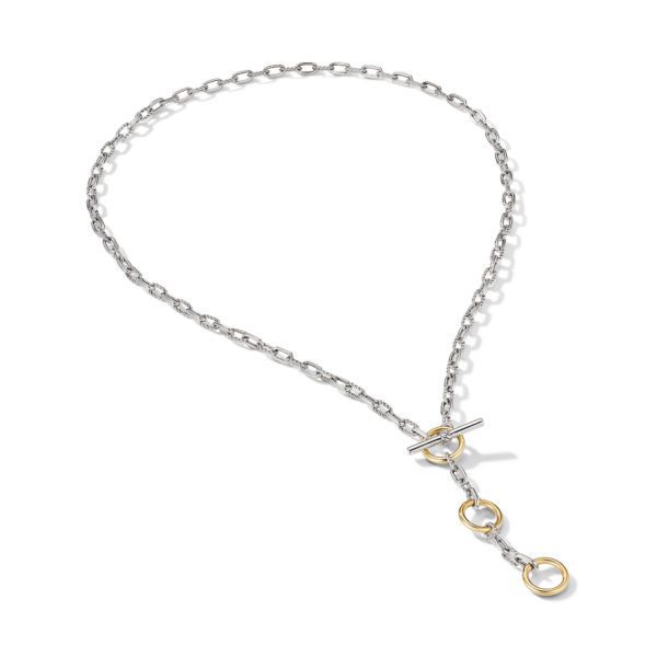 A silver chain necklace with a toggle clasp, adorned with three gold circular rings hanging in a vertical line near the clasp. The chain has small, interlocking links. The overall design of the necklace is simple yet elegant.