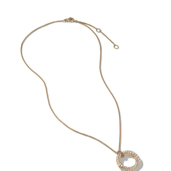 A delicate gold necklace with a circular pendant. The pendant features a smooth gold ring encircled by a smaller ring encrusted with small, sparkling stones. The necklace has a thin, elegant chain and a clasp at the top for fastening.