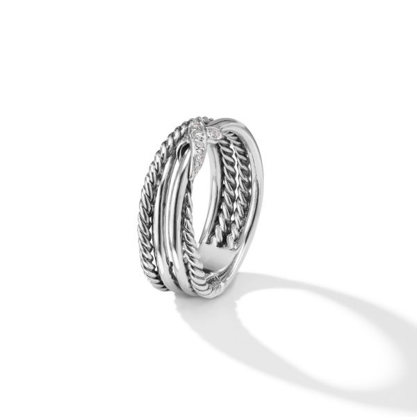 A silver ring featuring an intricate twisted design is displayed against a plain white background. The ring has a combination of smooth and rope-like textures intersecting at a point adorned with small, sparkling diamonds. Its shadow is visible on the right side.