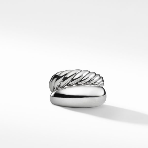 A shiny, silver ring with a contemporary, twisted design sits against a plain white background. The ring has smooth, polished sections combined with rope-like, textured elements. The shadow cast by the ring blends softly into the background.