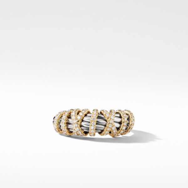 A gold ring with intertwined bands featuring encrusted diamonds and polished silver elements, set against a plain white background.