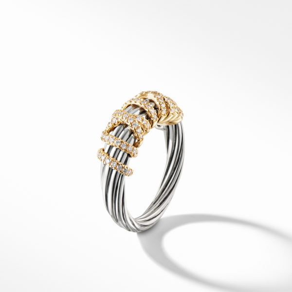 A twisted cable ring featuring intertwined silver and gold strands. The gold sections are adorned with small, sparkling diamonds, creating an elegant and luxurious design. The ring casts a soft shadow on a white background.