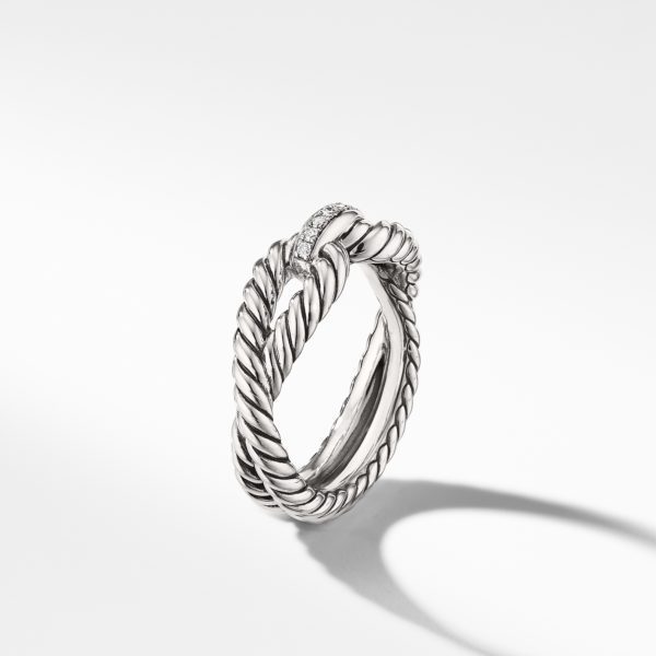 A silver twisted rope-style ring with a small section adorned with sparkling diamonds. The ring is photographed on a white background with a soft shadow beneath it.