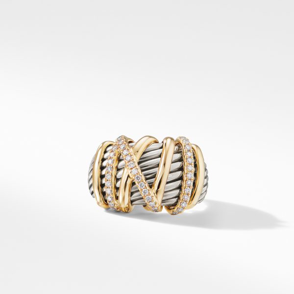 A stylish ring featuring a combination of twisted silver and gold bands, embellished with sparkling diamonds. The gold bands crisscross over the silver, adding a touch of elegance. The ring is set against a plain white background.