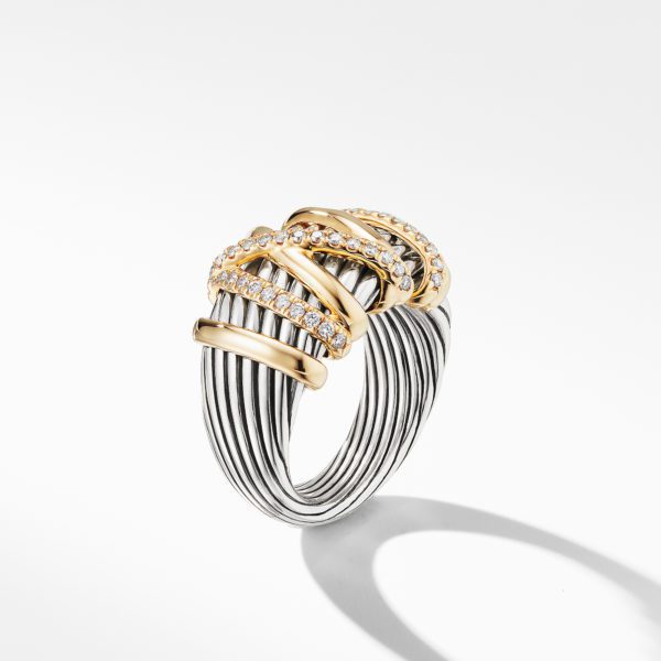 A silver coiled ring with multiple thin bands features three gold segments in the center, each adorned with small, sparkling diamonds. The ring is displayed against a white background with its shadow visible underneath.