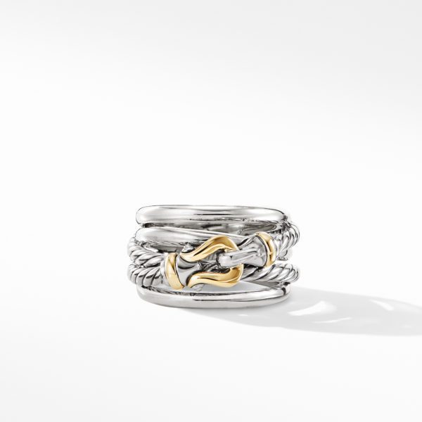 A stylish silver ring with multiple intertwined bands and intricate details, featuring a gold accent in the center. The ring is photographed against a plain white background, casting a subtle shadow.