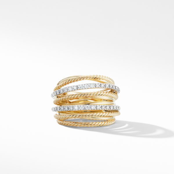 A gold ring with seven layered bands, each featuring a twisted rope-like design. Two of the bands are adorned with small, sparkling diamonds, adding a touch of elegance and sophistication to the piece. The ring is set against a plain white background.