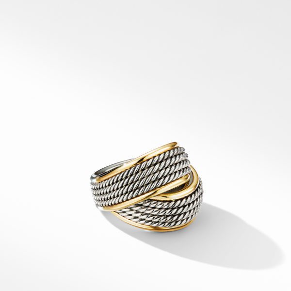 A twisted cable ring featuring intertwined strands of silver and gold. The braided design includes intricate details, creating a textured and elegant appearance. The ring casts a soft shadow on a smooth white background.