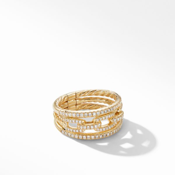 A gold bracelet with a twisted rope design intertwines with two rows of sparkling diamonds, casting a subtle shadow on a light gray surface. The elegant piece combines intricate metalwork with the brilliance of the gemstones.