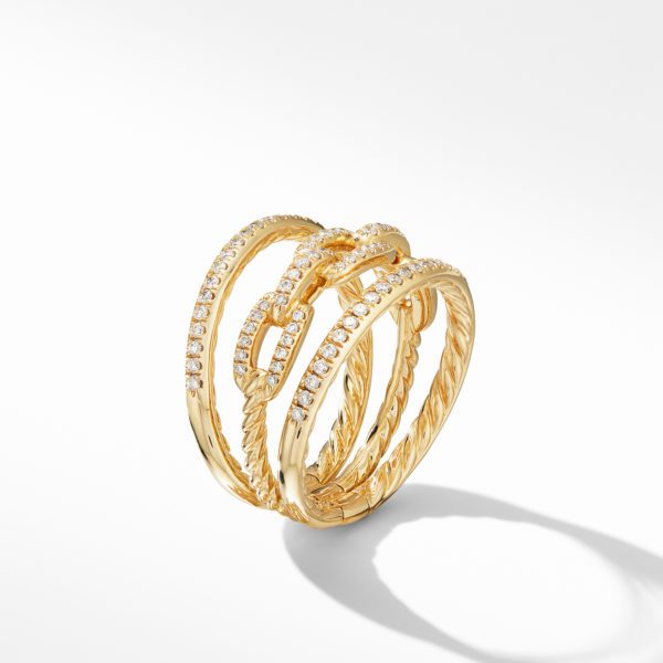 A gold ring with multiple intertwined bands is adorned with small, sparkling diamonds. The design features a mix of smooth and textured surfaces, creating an elegant and sophisticated look, prominently showcased against a plain white background.