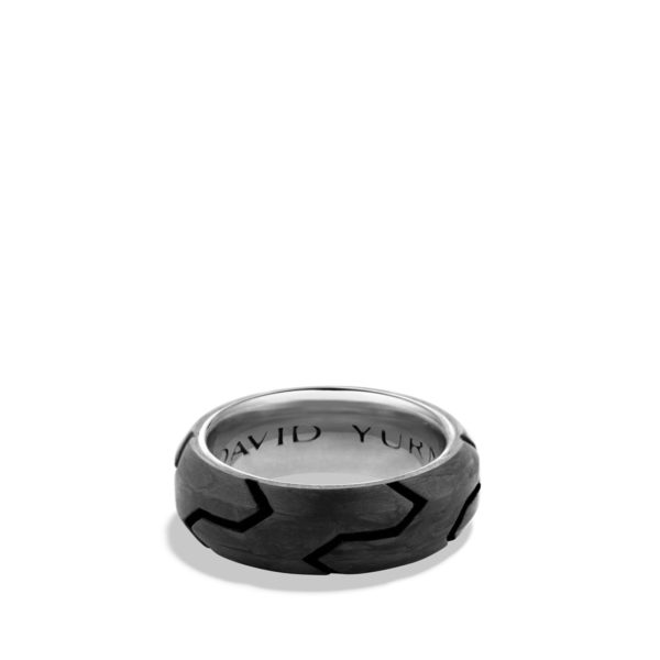 A chunky, polished metal ring with a dark geometric pattern engraved on the surface, revealing the words "DAVID YUR" partially visible inside the band against a white background.