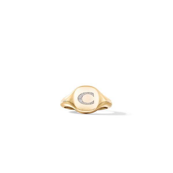 A gold signet ring featuring the letter "C" encrusted with small diamonds in the center. The ring has a smooth, polished finish and is set against a plain white background.