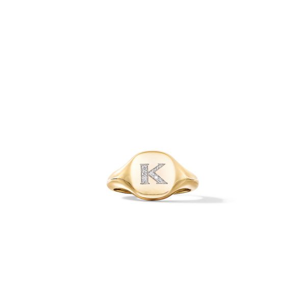 A gold signet ring featuring a bold, embossed letter "K" encrusted with small diamonds in the center. The ring has a polished, shiny finish and is photographed against a plain white background.