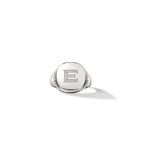 A silver signet ring featuring the letter "E" encrusted with small diamonds on its face. The ring is displayed on a clean white background, casting a slight shadow to the right.