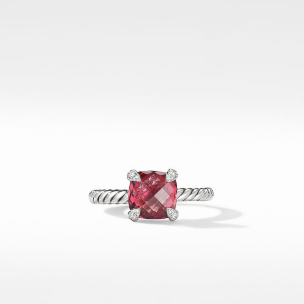 A silver ring with a twisted band design features a square-cut, pink gemstone at the center, held by four small diamond accents at each corner, against a plain white background.