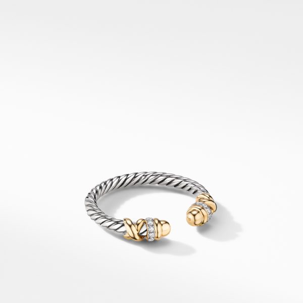 A stylish open-cuff bracelet with a twisted rope design made of silver and gold. Each end of the bracelet is adorned with a gold cap and decorative bands encrusted with small diamonds, adding a touch of sparkle. The bracelet rests on a white background.