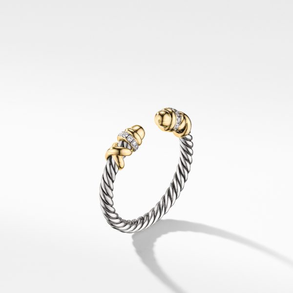 A silver cable-style bracelet with gold and diamond accents at the open ends. The twisted design features intricate detailing, with the gold elements adding a touch of elegance. The bracelet casts a subtle shadow on the white background.