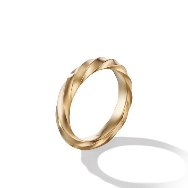 A gold twisted rope ring casting a shadow on a white background.