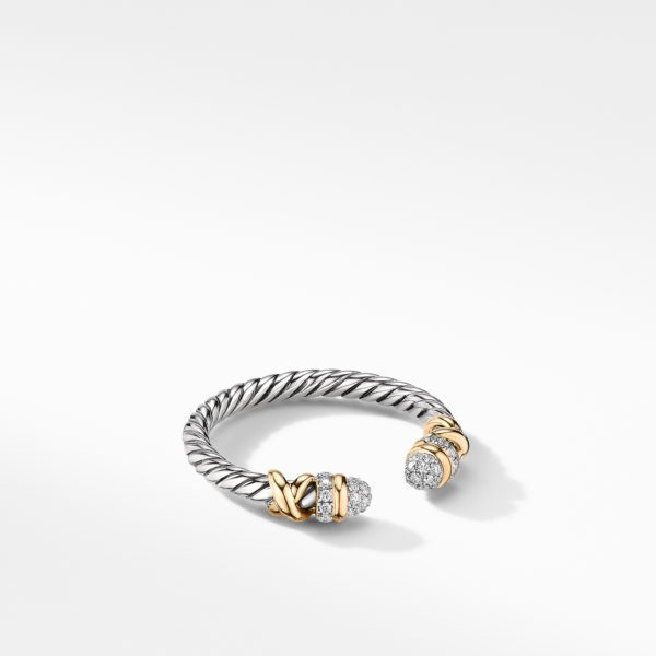 A sleek open cuff bracelet featuring twisted silver bands with gold accents and diamond-encrusted end caps, set against a plain white background. The design showcases a blend of elegance and modernity.