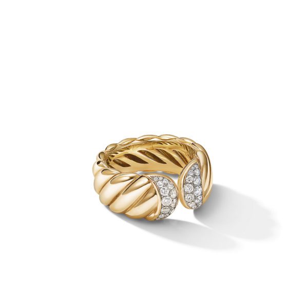 A gold ring with a twisted rope design featuring a prominent central section encrusted with small, sparkling diamonds. The ring casts a subtle shadow on the white background beneath it.