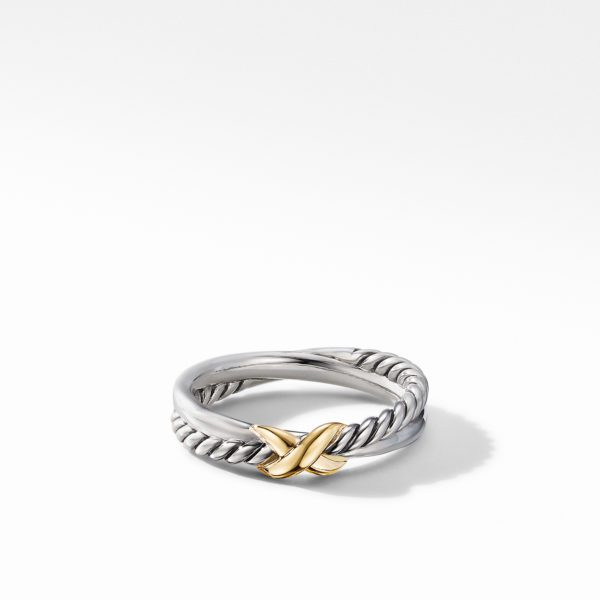 A silver twisted rope ring with a delicate gold X detail at the center, placed against a clean white background. The ring's intricate design combines both metallic finishes, creating a striking contrast between the silver and gold elements.