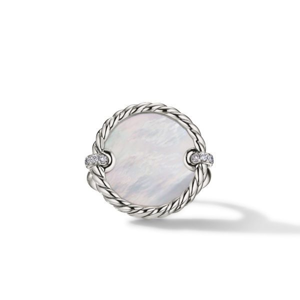 A silver ring featuring a large, round, mother-of-pearl centerpiece encased in a twisted rope design. The band is embellished with small diamonds on either side of the central stone. The ring casts a soft shadow on a white background.