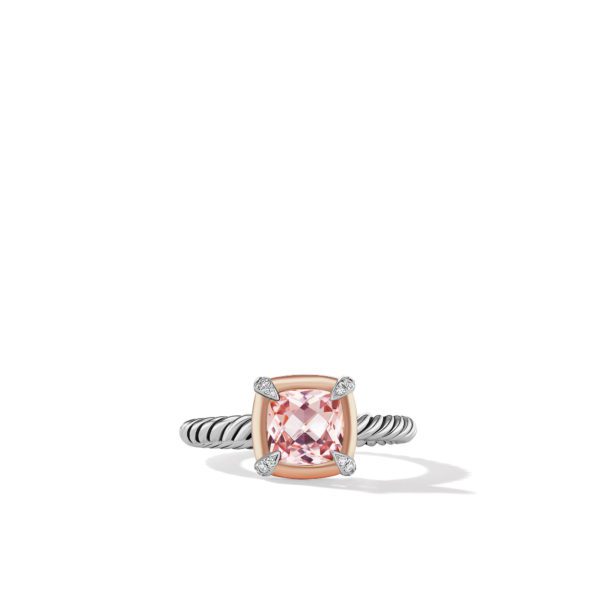 A silver twisted band ring featuring a cushion-cut pink gemstone set in a rose gold bezel with four prongs. Small diamonds are embedded in each prong, adding sparkle to the elegant design. The ring is centered on a white background.