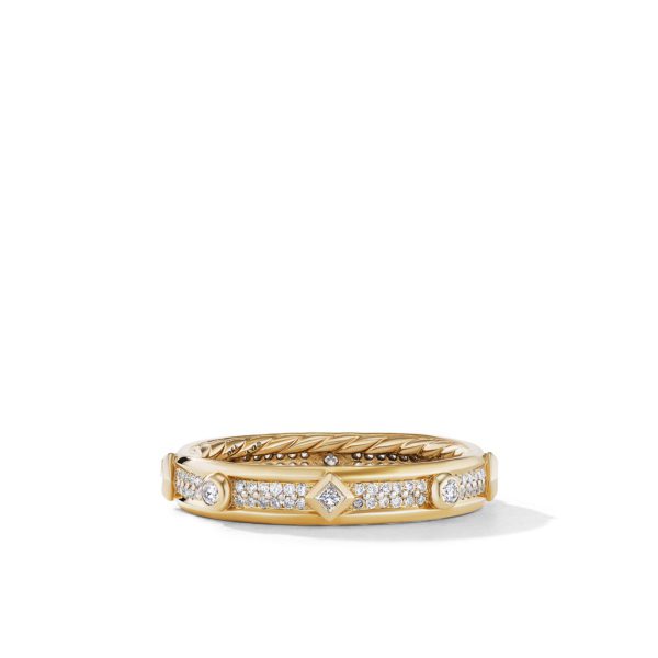 A gold ring with a textured band features a row of small, round diamonds set in the center, flanked by two larger round diamonds and a diamond-shaped design in the middle, all set in a straight line.