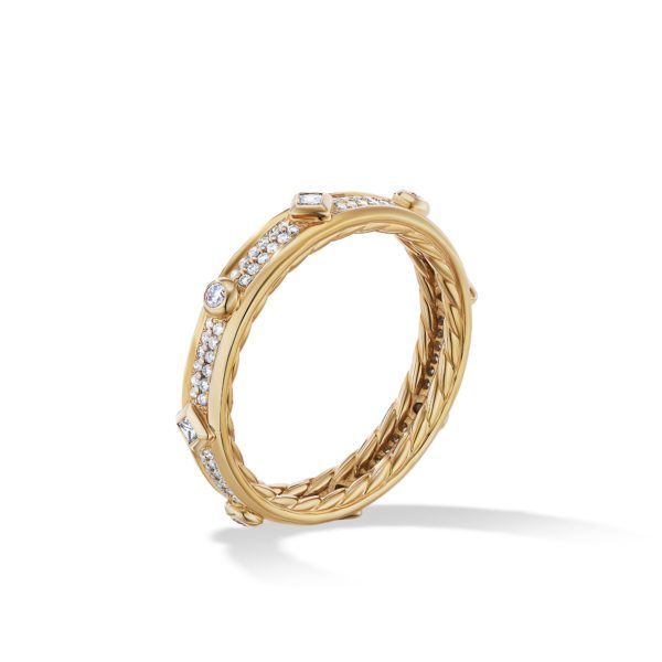 A gold ring with a twisted rope-like design, adorned with small, round-cut diamonds set evenly around the band. The ring's intricate details and sparkling stones catch the light, giving it a luxurious and elegant appearance. The background is white.