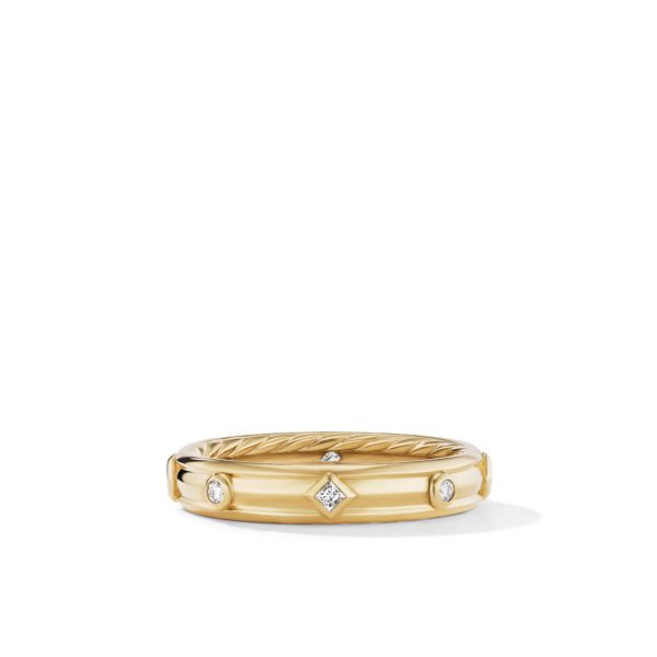 A gold ring featuring a combination of smooth and textured surfaces. The band is adorned with evenly spaced small diamonds in round and square settings. The background is plain white, emphasizing the ring's elegant design.