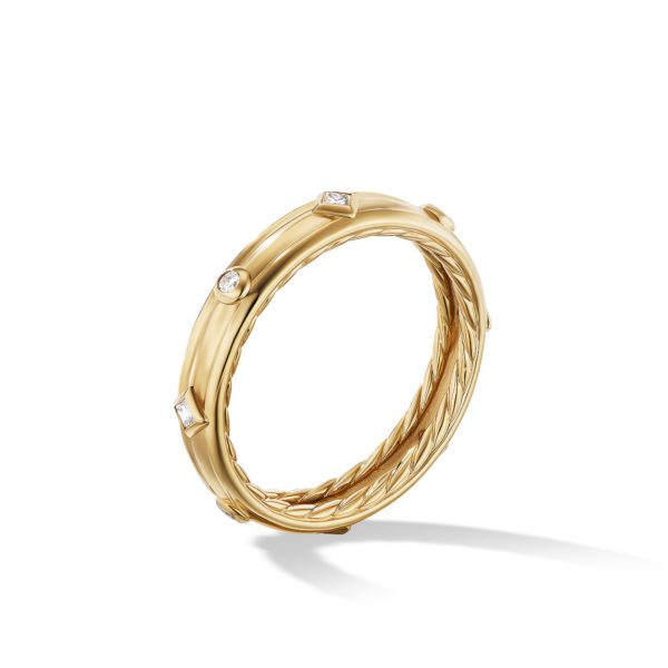 A finely crafted gold ring featuring a twisted design along its band. The smooth outer surface is adorned with small, evenly spaced diamonds embedded at regular intervals. The ring casts a gentle shadow against a plain white background.