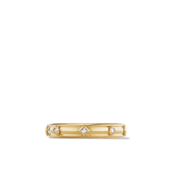 A gold ring featuring a geometric design with three small gemstones. One central square gemstone is flanked by two circular gemstones, evenly spaced along the gold band. The ring is displayed on a plain white background.