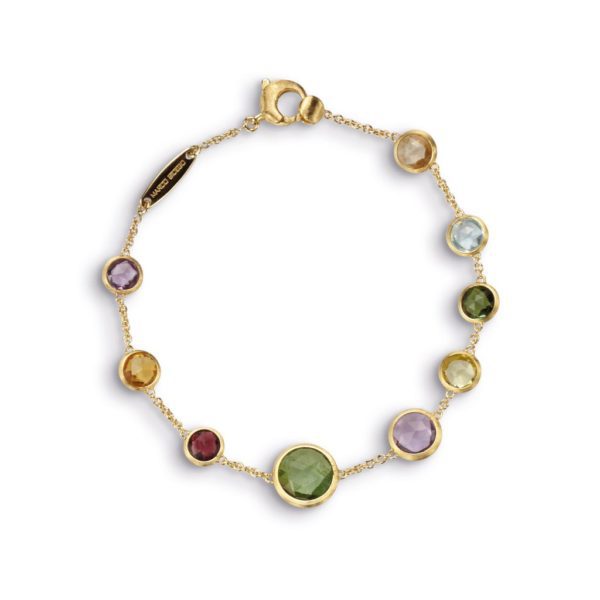 The JAIPUR BRACELET features a delicate gold chain adorned with nine bezel-set, multi-colored gemstones arranged in a varied pattern. The vibrant stones come in green, purple, blue, and yellow hues and the bracelet is secured with a lobster clasp.