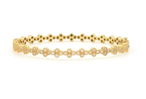 The JudeFrances Provence Continuous Diamond Quad Bangle is a delicate gold bracelet with a floral design, adorned with small clusters of sparkling diamonds arranged in a symmetrical pattern around its circumference. The bracelet boasts a polished finish that enhances its elegant and luxurious appearance.