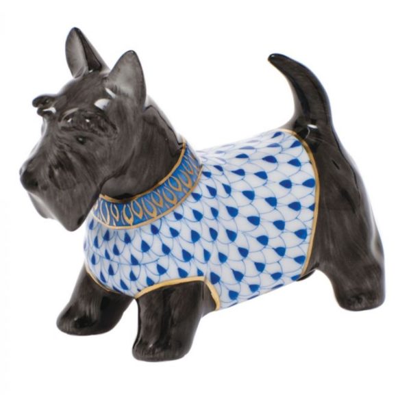 The Herend Scottie McDuff Figurine - Sapphire is a ceramic depiction of a black Scottish Terrier dog, featuring a detailed white and blue patterned coat adorned with gold accents. The dog's ears are perked up, and its tail is curved upward.