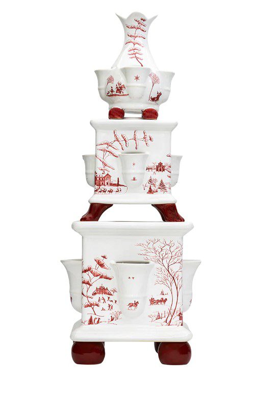 The Juliska Country Estate Tulipiere - Winter Frolic is a decorative, multi-tiered ceramic stove adorned with red pastoral and nature-themed illustrations. It features a bird-shaped spout on the top and progressively larger sections below, each showcasing intricate red designs. The base is supported by four rounded red feet.