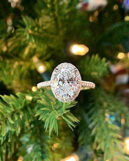 Engagement ring set in lit garland for a holiday proposal