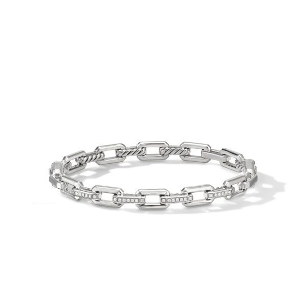 A silver bracelet with a chain-link design, featuring alternating rectangular links adorned with small, embedded crystals. The bracelet is sleek and modern, lying flat against a white background with a subtle shadow.