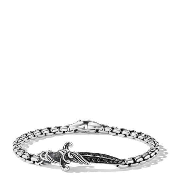 A silver chain bracelet featuring an ornate, dagger-shaped centerpiece with black accents. The chain is composed of rectangular links, and the dagger showcases intricate detailing on its hilt and blade.