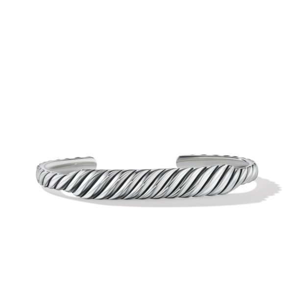 A polished silver cuff bracelet with a twisted rope design is displayed against a plain, white background. The bracelet has an open-ended design, allowing for easy adjustment and fit. Shadows are visible beneath it.