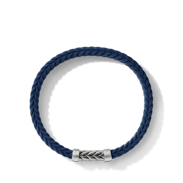 A braided navy blue leather bracelet with a silver clasp is displayed against a white background. The clasp features an intricate engraved pattern, adding a touch of elegance to the simple yet stylish design.