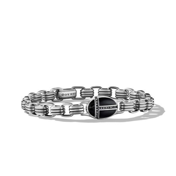 A silver bracelet featuring a chain-link design with a black, shield-shaped clasp adorned with small diamonds. The clasp is engraved with "DY 925." The bracelet has a sleek and polished appearance.