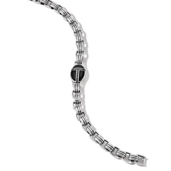 A silver metal bracelet with a black and silver clasp lies against a white background. The bracelet features interlocking rectangular links, and the clasp has a sleek, modern design. The bracelet is arranged in a gentle, curved shape.