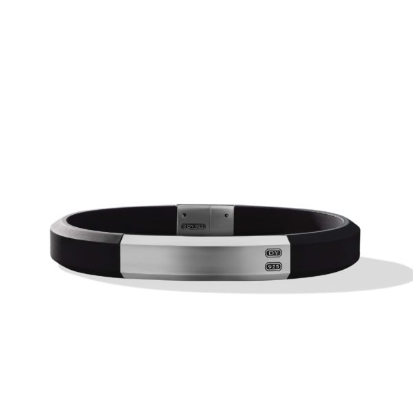 A sleek black bracelet with a silver rectangular clasp is shown. The clasp has a polished finish and includes engraved details, featuring the letters "DY" and other small markings. The bracelet casts a subtle shadow on a white background.