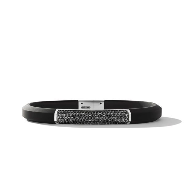 A sleek black bracelet with a rectangular centerpiece encrusted with small, sparkling black stones. The bracelet has a modern, minimalist design and a silver clasp, creating a stylish contrast against the dark band. The background is plain white.