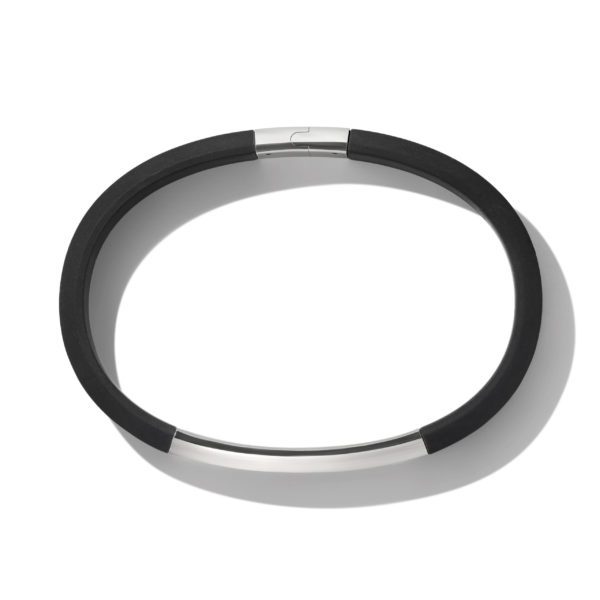 A black and silver, circular-shaped fitness tracker with a sleek and minimalist design. The device has a clasp mechanism and casts a shadow on the white background.