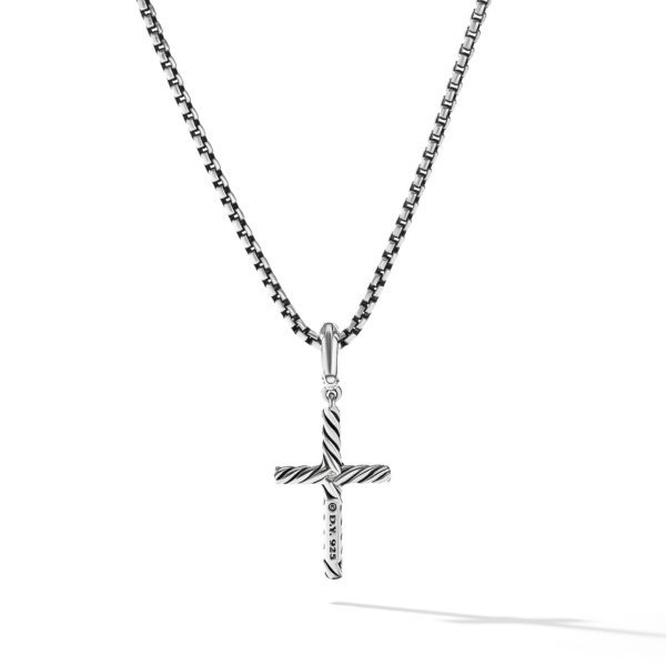 A silver cross pendant with a striped pattern hangs from a silver box chain necklace against a white background. The cross features a small vertical bar with engraved text.