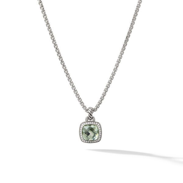 A silver necklace featuring a square-shaped pendant with rounded edges. The pendant has a green gemstone center surrounded by a halo of small clear stones, and it is strung on a fine silver chain. The necklace is photographed against a white background with a shadow.