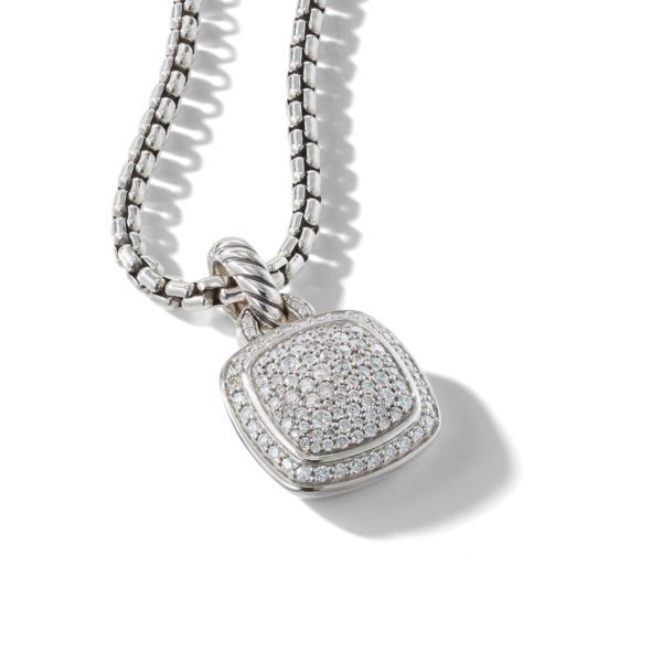 A close-up image of a silver necklace with a square-shaped pendant encrusted with small diamonds. The pendant hangs on a thick, chain-link necklace, and the piece is displayed against a white background, casting a soft shadow.